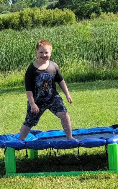 boy jumping with water