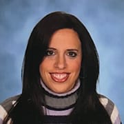 Individual named Julie Rodgers sporting black hair and a striped turtle neck.