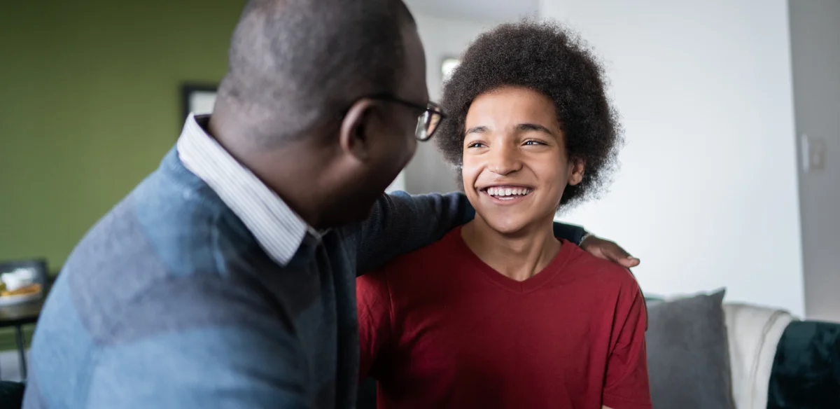 Father and son smiling