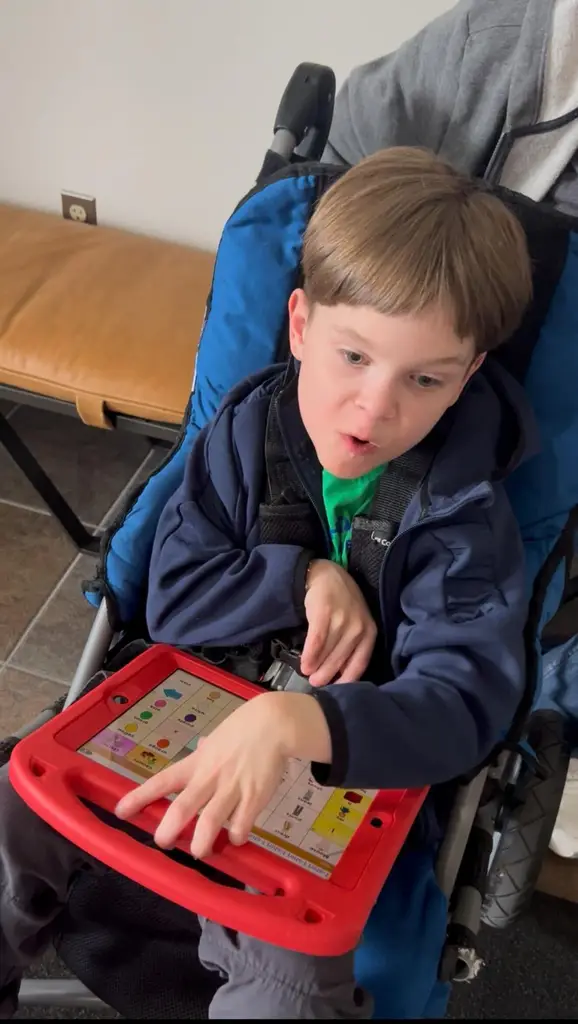photo of student Aydan playing with a learning game. 