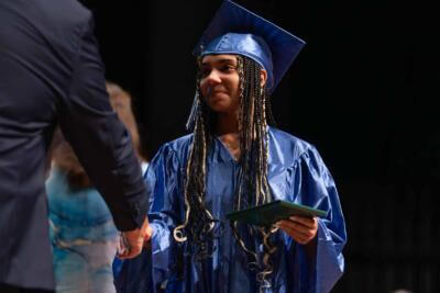 Graduate student shaking hands with a teacher