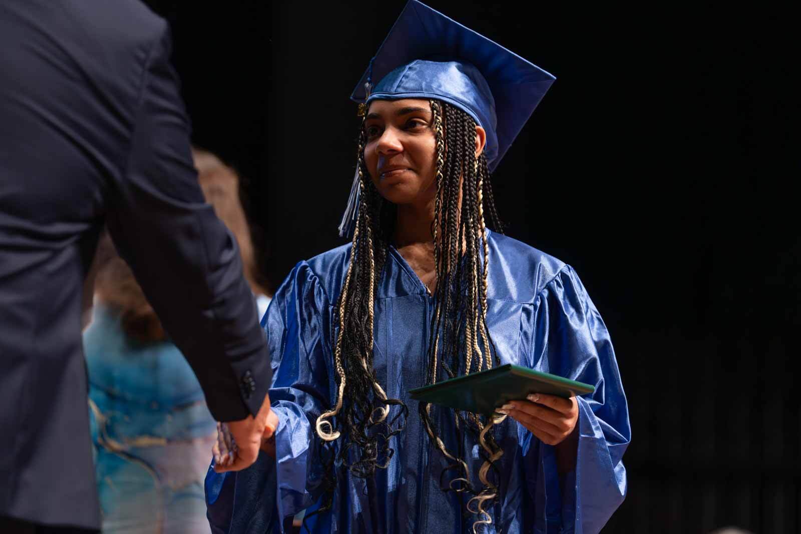 Graduate student shaking hands with a teacher