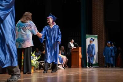 Graduate student shaking hands with a teacher