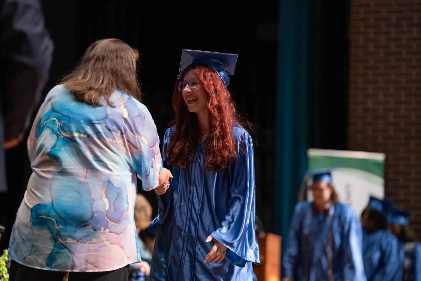 Graduate student shaking hands with a teacher