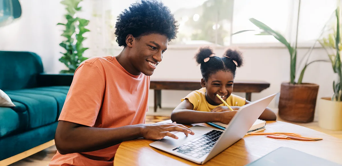 boy and little girl studying at home and using the computer