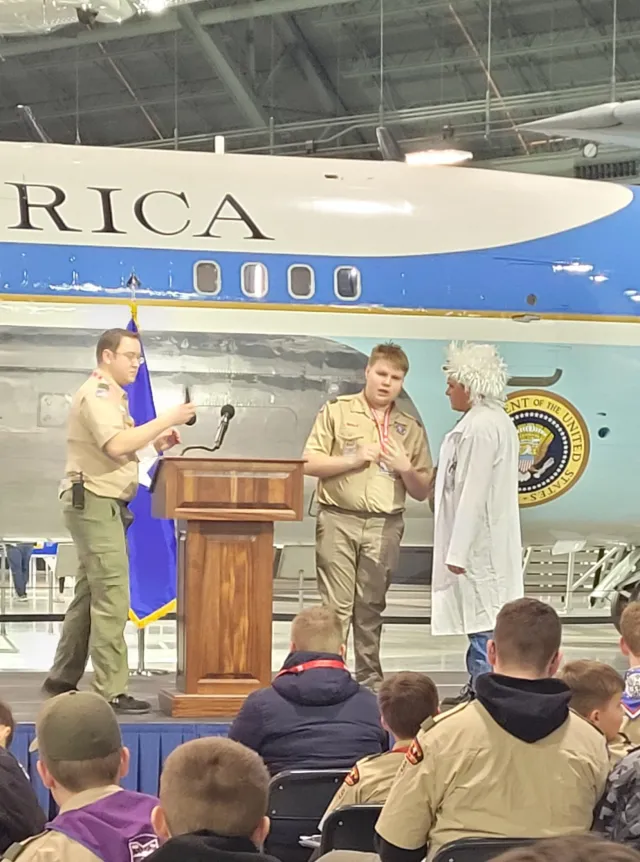Leelan Gold (center) leads a group of 600 people, including fellow scouts, in the opening ceremony at a scout event at the National Museum of the United States Air Force in Dayton, Ohio, in December, with Air Force One in the background. (Photo provided)
